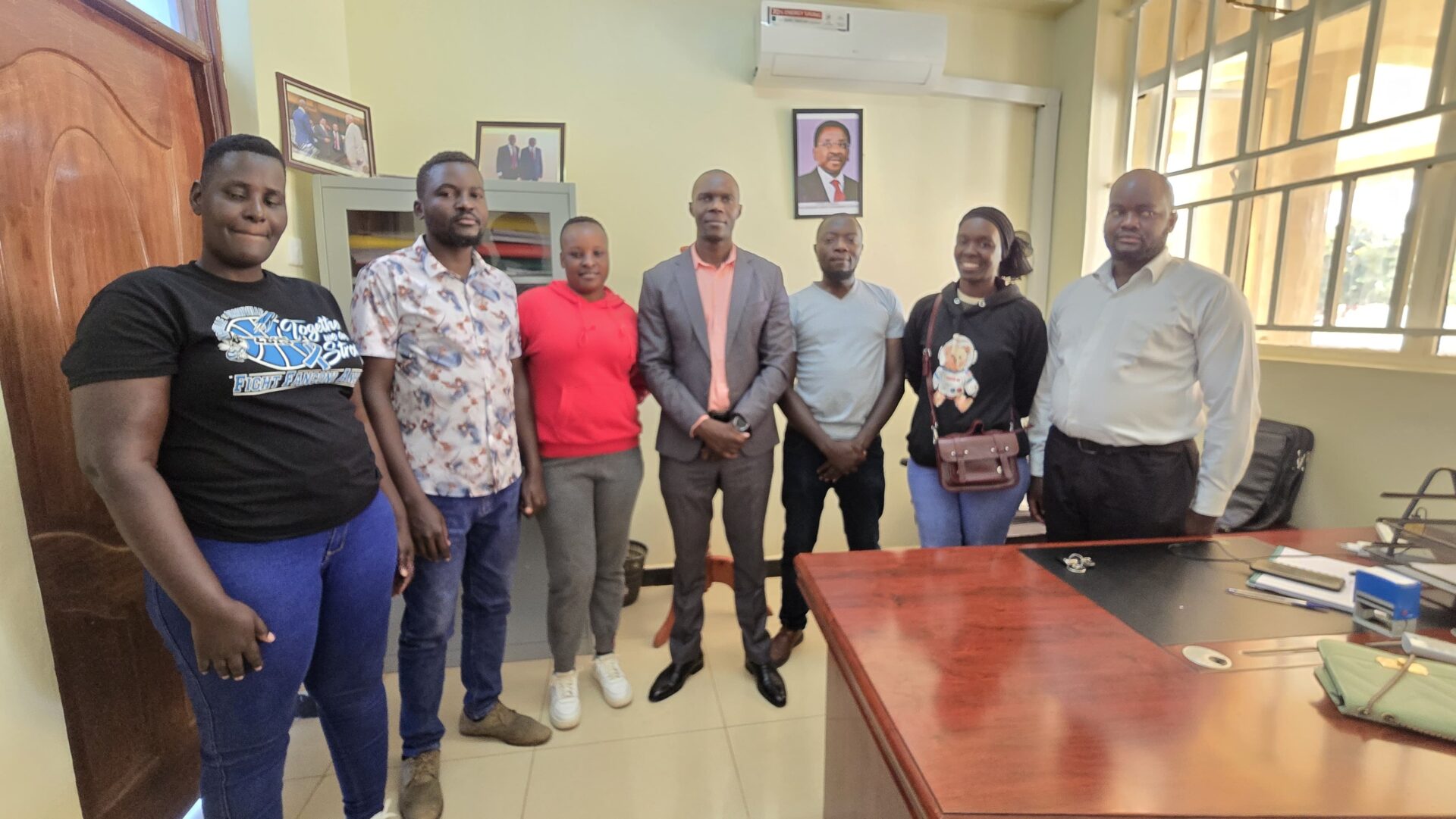 A group of youth leaders, including Ouma Onyango and Duncan Oluoch, standing inside the Siaya County Governor's office during a consultative meeting on the unemployment crisis.