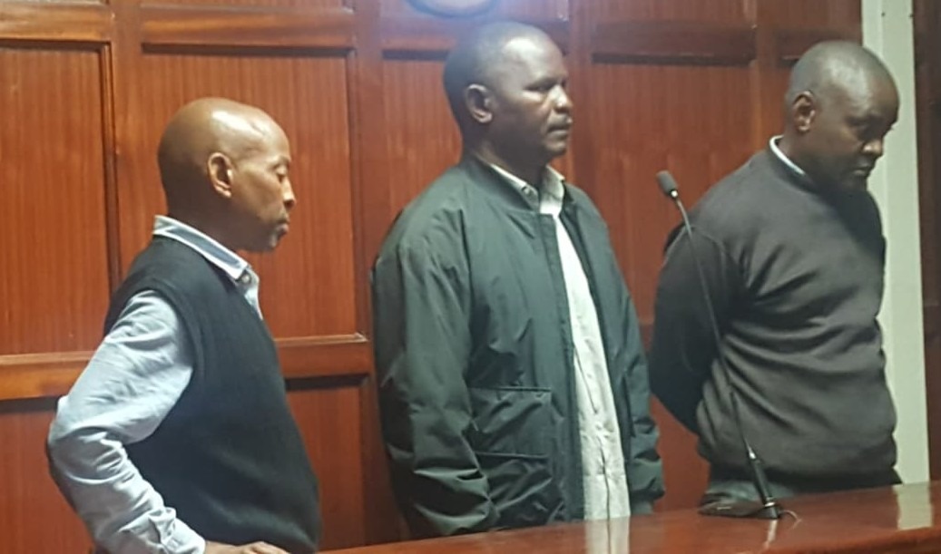 Afya SACCO officials Evans Mung’ahu Kola, Patrick Kuya Lubako, and Mumina Mutinda Ing’ui seated in the dock at the Milimani Law Courts during a past hearing.
