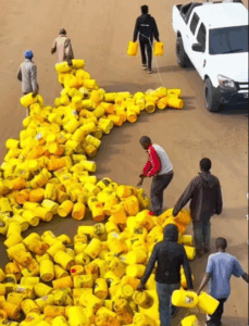 Comedian and activist Eric Omondi pulls empty jerricans on road in fuel price protest