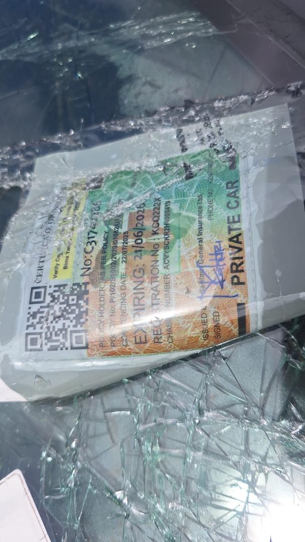 The insurance certificate of vehicle registration number KCQ 222X, visible amid shattered glass at the crash scene along Ngong Road, Nairobi, on April 25, 2026.